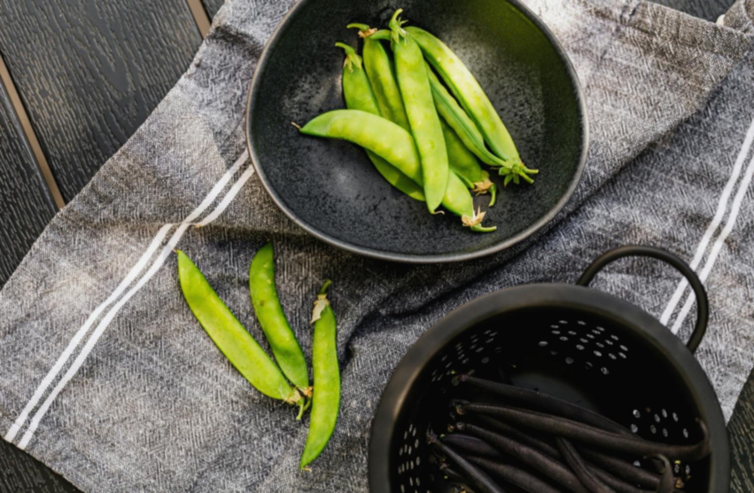 Professional pizza chef demonstrating wood-fired oven techniques to students
